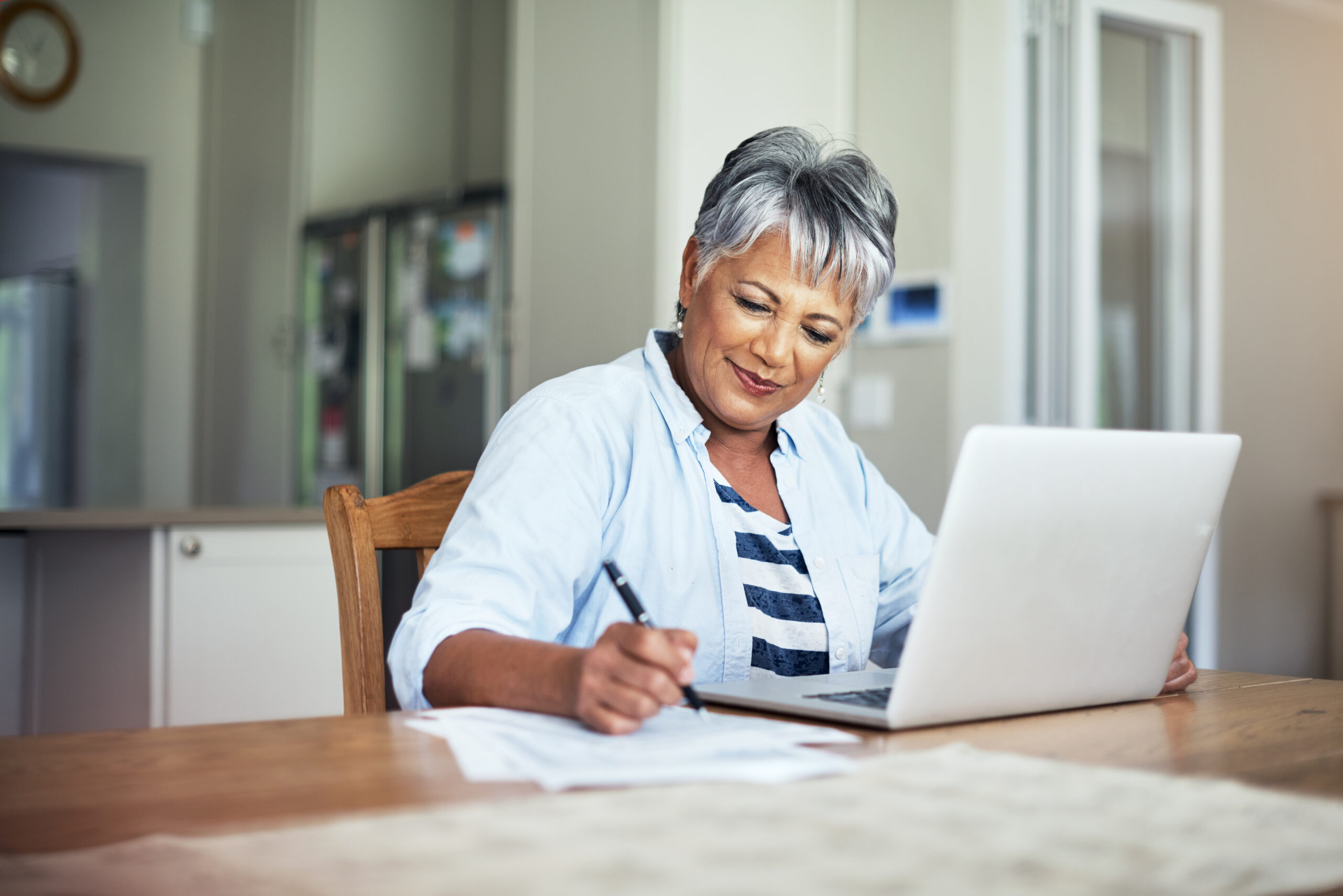 Cropped shot of a senior woman using a laptop to do the household finances