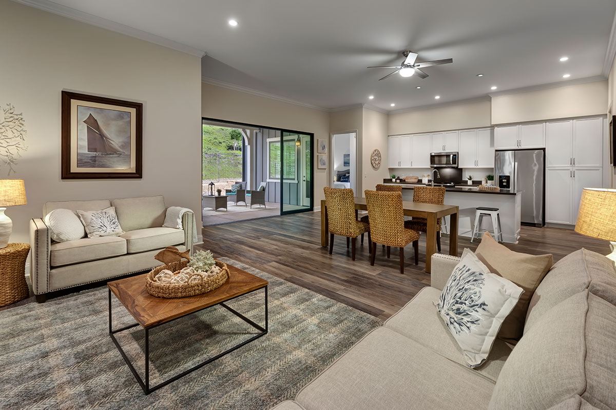 the living room and kitchen open concept of a private residence