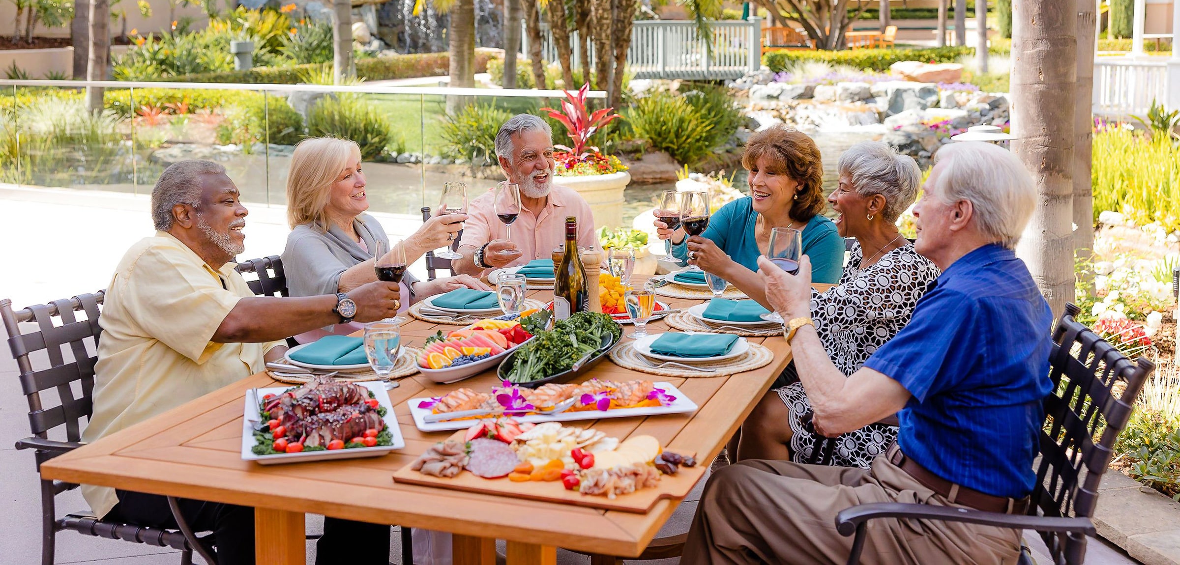 lacosta-2024-600x600-13 A group of residents drinking wine and eating charcuterie