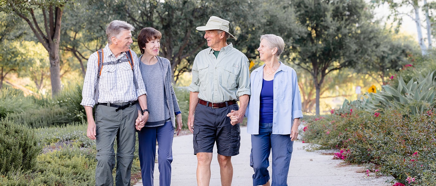 reata-2023-1400x600-8 A group of residents walking around the grounds of Wisteria